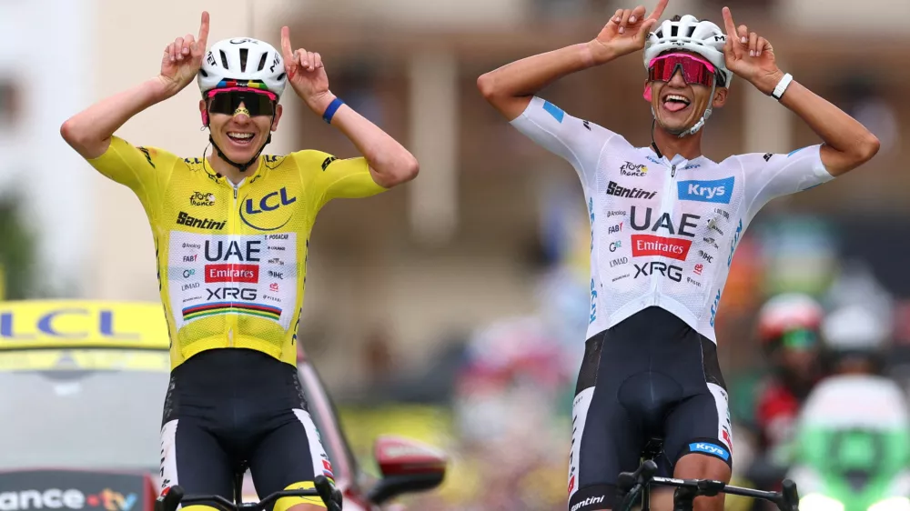 Cycling - Tour de France - Stage 20 - Le Bourg d'Oisans to Alpe d'Huez - Alpe d'Huez, France - July 25, 2026 UAE Team Emirates XRG's Tadej Pogacar wearing the yellow jersey and UAE Team Emirates XRG's Isaac Del Toro wearing the white jersey react at the end of stage 20 REUTERS/Gonzalo Fuentes   TPX IMAGES OF THE DAY