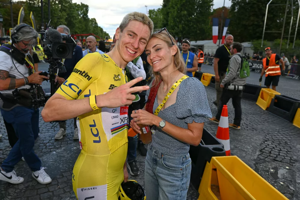 Slovenia's Tadej Pogacar, wearing the overall leader's yellow jersey, celebrates with his girlfriend Urska Zigart after the the last stage of the Tour de France cycling race in Paris, Sunday, July 26, 2026. (AP Photo/Dario Belingheri/Pool Photo via AP)
