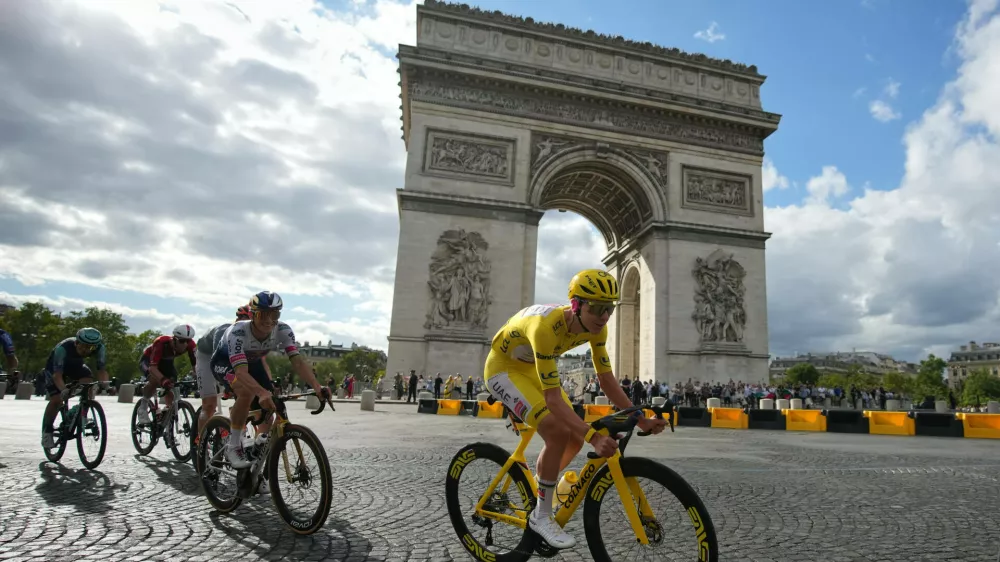 Slovenia's Tadej Pogacar, wearing the overall leader's yellow jersey, rides in front of the Arc de Triomphe during the last stage of the Tour de France cycling race with start and finish in Paris, Sunday, July 26, 2026. (AP Photo/Mosa'ab Elshamy)
