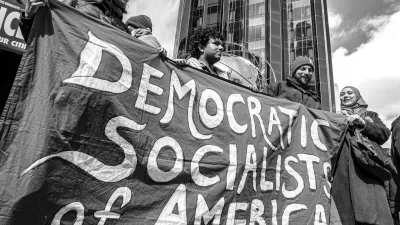 March 28, 2026, New York, New York, USA: A black-and-white photograph shows demonstrators holding a Democratic Socialists of America banner during the No Kings protest in Manhattan, with Trump International Hotel and Tower in the background. (Credit Image: © Bianca Otero/ZUMA Press Wire)