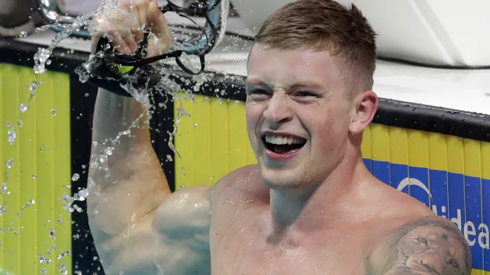Britain's Adam Peaty celebrates after setting a new world record in a men's 50-meter breaststroke semifinal during the swimming competitions of the World Aquatics Championships in Budapest, Hungary, Tuesday, July 25, 2017. (AP Photo/Michael Sohn)