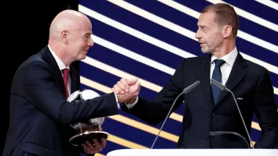 FILE PHOTO: Soccer Football - 50th Ordinary UEFA Congress - Brussels Expo, Brussels, Belgium - February 12, 2026 UEFA president Aleksander Ceferin and FIFA president Gianni Infantino shake hands during the event REUTERS/Benoit Tessier/File Photo