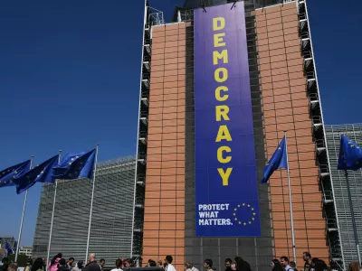 Visitors wait in line to get into an open house to celebrate Europe Day at EU headquarters in Brussels, Saturday, May 9, 2026. (AP Photo/Virginia Mayo)