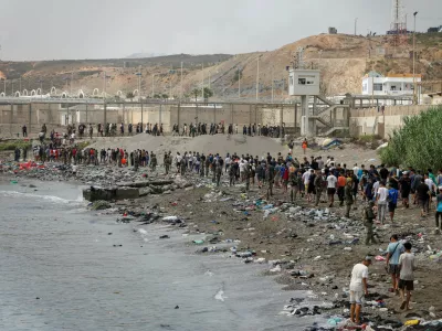 People walk towards the border with Morocco leaving Spain, amid mass crossings of migrants on foot and by sea from Morocco into Spanish territory, in Ceuta, Spain, July 31, 2026. REUTERS/Jon Nazca   TPX IMAGES OF THE DAY