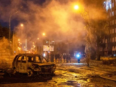 A burned car is seen after a Russian missile attack in Kyiv, Ukraine, Saturday, Aug. 1, 2026. (AP Photo/Dan Bashakov)