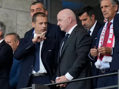 FILE - UEFA President Aleksander Ceferin, left, talks to FIFA President Gianni Infantino before a round of sixteen match between Switzerland and Italy at the Euro 2024 soccer tournament in Berlin, Germany, Saturday, June 29, 2024. (AP Photo/Matthias Schrader, File)