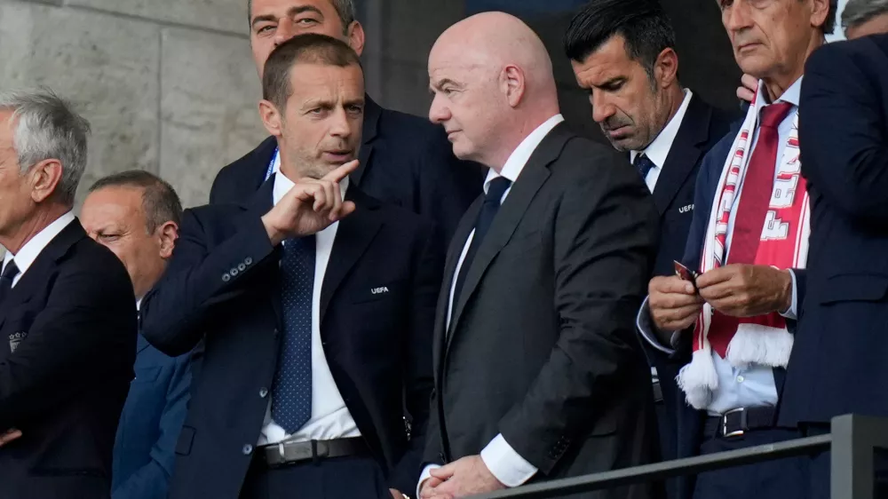 FILE - UEFA President Aleksander Ceferin, left, talks to FIFA President Gianni Infantino before a round of sixteen match between Switzerland and Italy at the Euro 2024 soccer tournament in Berlin, Germany, Saturday, June 29, 2024. (AP Photo/Matthias Schrader, File)
