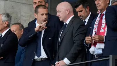 FILE - UEFA President Aleksander Ceferin, left, talks to FIFA President Gianni Infantino before a round of sixteen match between Switzerland and Italy at the Euro 2024 soccer tournament in Berlin, Germany, Saturday, June 29, 2024. (AP Photo/Matthias Schrader, File)