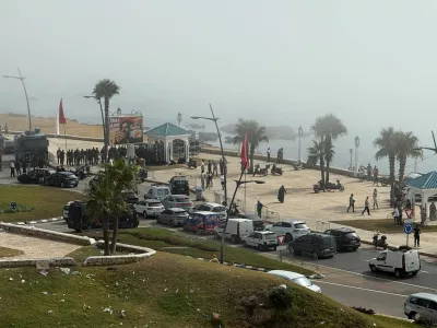 Security forces stand guard in Fnideq, Morocco, August 1, 2026, as migrants gather after crossing from the Spanish enclave of Ceuta to the Moroccan side of the border. Picture taken using a mobile phone. REUTERS/Stringer