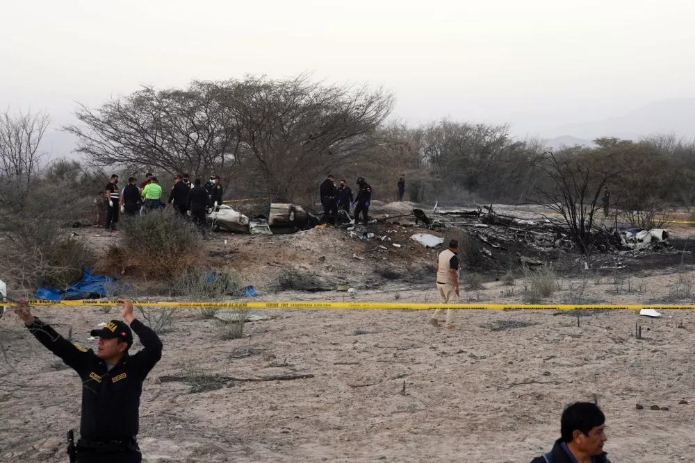 Police inspect the wreckage of a plane that crashed during a sightseeing flight carrying tourists over the Nazca Lines in Peru, Saturday, Aug. 1, 2026. (AP Photo/Genry Bautista)