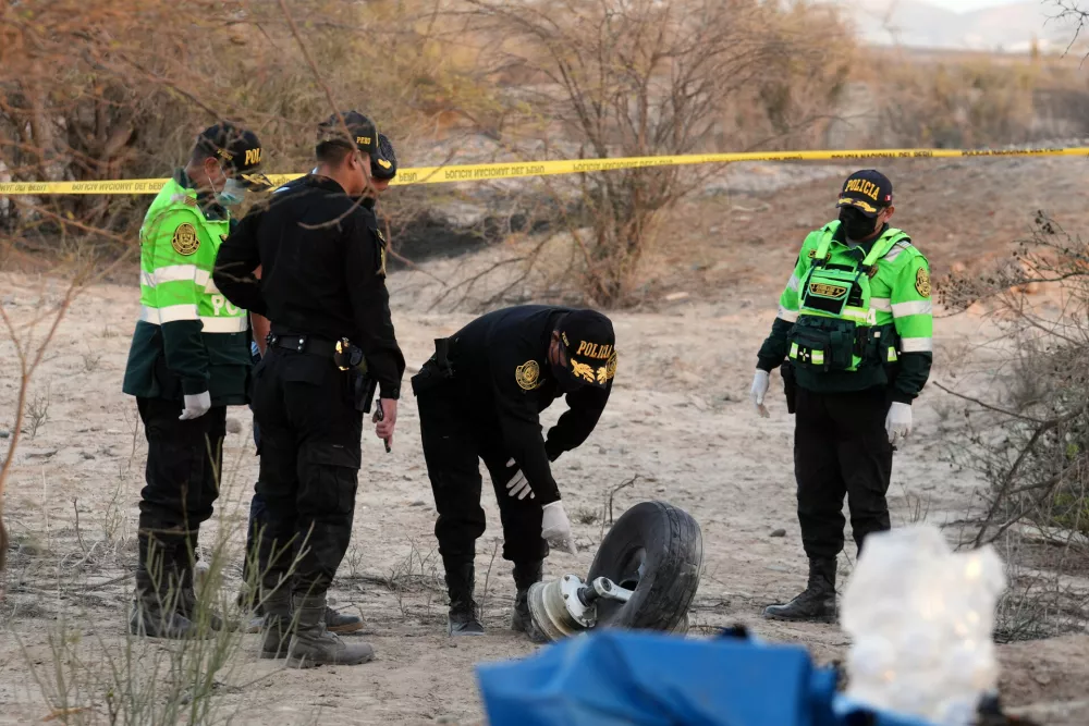 Police inspect the wreckage of a plane that crashed during a sightseeing flight carrying tourists over the Nazca Lines in Peru, Saturday, Aug. 1, 2026. (AP Photo/Genry Bautista)