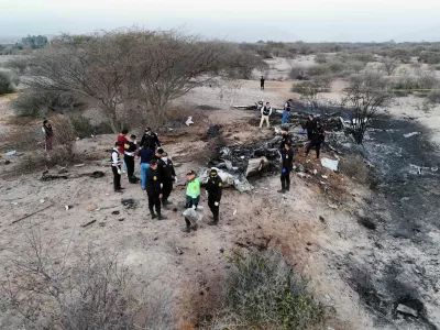 Police inspect the wreckage of a plane that crashed during a sightseeing flight carrying tourists over the Nazca Lines in Peru, Saturday, Aug. 1, 2026. (AP Photo/Genry Bautista)