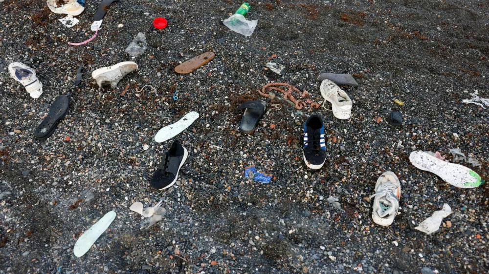 Shoes belonging to migrants lie on El Tarajal beach, amid mass crossings of migrants on foot and by sea from Morocco into Spanish territory, in Ceuta, Spain, July 31, 2026. REUTERS/Jon Nazca