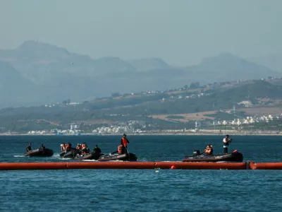 Members of the Royal Moroccan Navy patrol on the Moroccan side of the floating barrier off the border with Morocco, following mass crossings of migrants on foot and by sea from Morocco into Spanish territory, as seen from Ceuta, Spain, August 2, 2026. REUTERS/Violeta Santos Moura   TPX IMAGES OF THE DAY