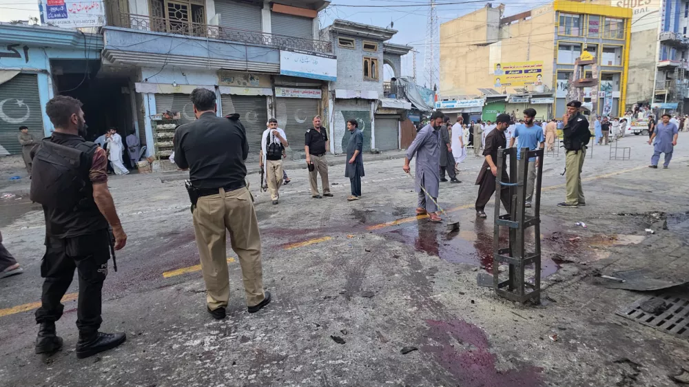 Police officers examine the site following a suicide bombing, in Kabal, a town in the Swat Valley in Pakistan's Khyber Pakhtunkhwa province, Sunday, Aug. 2, 2026. (AP Photo/Sherin Zada)