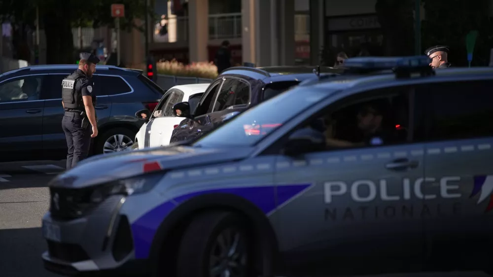 A France Police officer controls cars at a check point ahead of the G7 summit in Evian-les-Bains, France, Monday, June 15, 2026. (AP Photo/Christophe Ena)