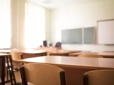 School classroom in blur background without young student; Blurry view of class room no kid or teacher with chairs and tables in campus.