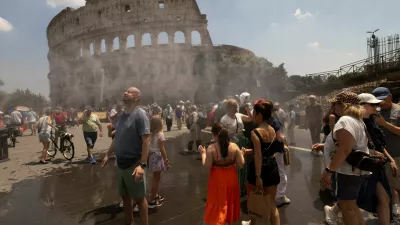 People cool off under a water mist near the Colosseum as Italy's Civil Protection deploys measures to help residents and tourists cope with a heatwave, in Rome, Italy, June 26, 2026. REUTERS/Remo Casilli