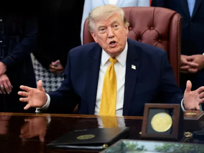 FILE PHOTO: U.S. President Donald Trump answers questions from the media after signing an executive order establishing the President's Military Spouse Commission to be chaired by Jennifer Rauchet, wife of Secretary of Defense Pete Hegseth, in the Oval Office at the White House in Washington, D.C., U.S., August 3, 2026. REUTERS/Evelyn Hockstein/File Photo