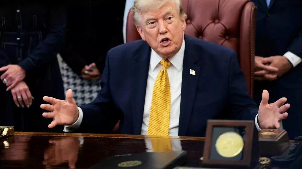 FILE PHOTO: U.S. President Donald Trump answers questions from the media after signing an executive order establishing the President's Military Spouse Commission to be chaired by Jennifer Rauchet, wife of Secretary of Defense Pete Hegseth, in the Oval Office at the White House in Washington, D.C., U.S., August 3, 2026. REUTERS/Evelyn Hockstein/File Photo
