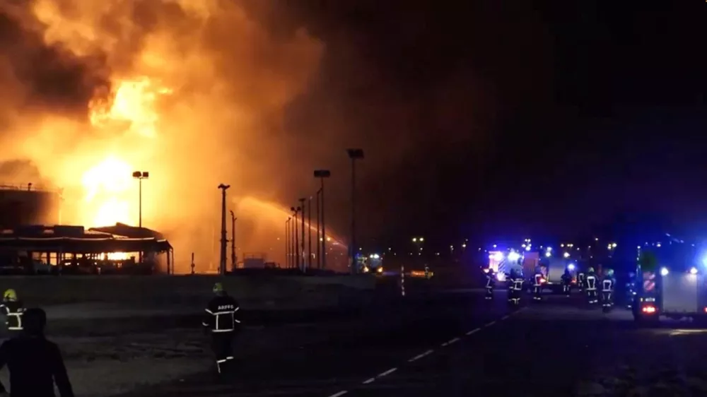 Firefighters work at the site after reported Iranian strikes triggered fire at fuel tanks near the airport, in Muharraq, Bahrain March 12, 2026, in this screengrab taken from a handout video.  Bahrain Information Ministry/Handout via REUTERS  THIS IMAGE HAS BEEN SUPPLIED BY A THIRD PARTY. VERIFICATION: - Tanks, utility poles and buildings matched file and satellite imagery - Coordinates of the facility on fire: 26.26282799860747, 50.65329169205331 - Exact time not verified but no older version of the video was found posted online before March 12 - Bahrain's Ministry of Interior wrote on X that fuel tanks at a facility in Muharraq were targeted by Iranian forces on the morning of March 12