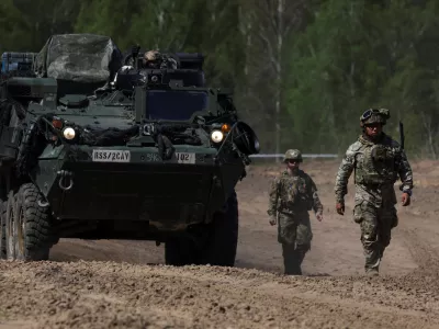 U.S. Army soldiers walk in formation during the Sword 26 exercise, approaching a MEDEVAC vehicle as NATO forces demonstrate innovation in battlefield casualty evacuation using drones and medical tech in Bemowo Piskie, Poland, May 11, 2026. REUTERS/Kuba Stezycki
