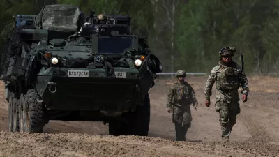 U.S. Army soldiers walk in formation during the Sword 26 exercise, approaching a MEDEVAC vehicle as NATO forces demonstrate innovation in battlefield casualty evacuation using drones and medical tech in Bemowo Piskie, Poland, May 11, 2026. REUTERS/Kuba Stezycki