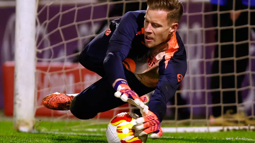 FILE - Barcelona's goalkeeper Marc-Andre ter Stegen warms up prior to the start of the Copa del Rey soccer match between Guadalajara and Barcelona in Guadalajara, Spain, Dec. 16, 2025. (AP Photo/Rudy Garcia, File)