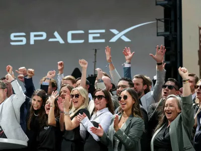 FILE PHOTO: SpaceX leadership members and guests celebrate on a balcony at the Nasdaq MarketSite on the day of SpaceX's initial public offering (IPO), in New York City, U.S., June 12, 2026. REUTERS/Brendan McDermid/File Photo