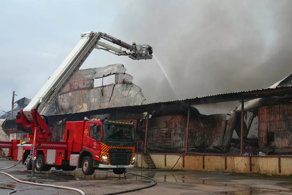 Firefighters put out a fire after Russian missiles hit a food warehouse near Kyiv, Ukraine, Wednesday, Aug. 5, 2026. (AP Photo/Efrem Lukatsky)