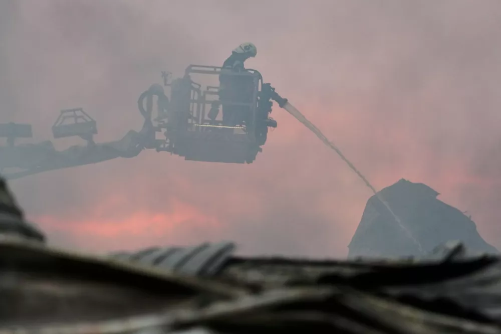 Firefighters put out a fire after Russian missiles hit a food warehouse near Kyiv, Ukraine, Wednesday, Aug. 5, 2026. (AP Photo/Efrem Lukatsky)