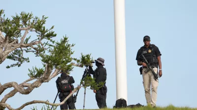 Members of the U.S. Secret Service watch before Marine One with President Donald Trump aboard, lands near Trump National Golf Club Los Angeles, Tuesday, Aug. 4, 2026, in Rancho Palos Verdes, Calif. (AP Photo/Mark Schiefelbein)
