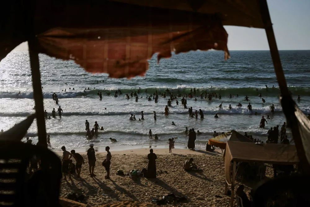 Palestinians cool off in the Mediterranean Sea during a heat wave in Nuseirat, central Gaza Strip, Thursday, July 30, 2026. (AP Photo/Abdel Kareem Hana)