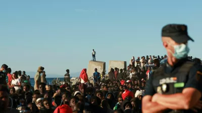 Migrants wait in line to receive food and beverage from the Red Cross, following mass crossings of migrants on foot and by sea from Morocco into Spanish territory, in Ceuta, Spain, August 3, 2026. REUTERS/Violeta Santos Moura
