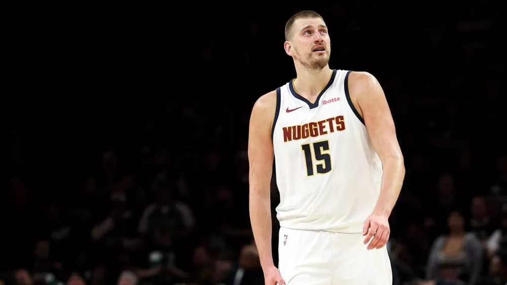 Denver Nuggets center Nikola Jokic (15) looks on during the second half of Game 6 of a first-round NBA basketball playoffs series against the Minnesota Timberwolves, Thursday, April 30, 2026, in Minneapolis. (AP Photo/Matt Krohn)