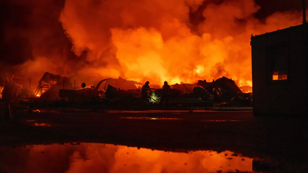 Firefighters put out a fire after Russian missiles hit a warehouse in Kyiv, Ukraine, Wednesday, Aug. 5, 2026. (AP Photo/Dan Bashakov)