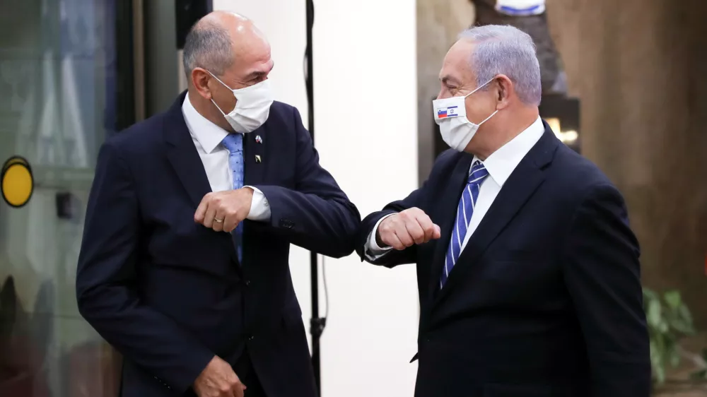 Slovenian Prime Minister Janez Jansa and Israeli Prime minister Benjamin Netanyahu wear protective masks as they meet in Jerusalem December 8, 2020. Ohad Zwigenberg/Pool via REUTERS