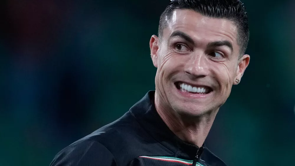 Portugal's Cristiano Ronaldo smiles as he warms up for a World Cup 2026 group F qualifying soccer match between Portugal and Hungary in Lisbon, Tuesday, Oct. 14, 2025. (AP Photo/Armando Franca)