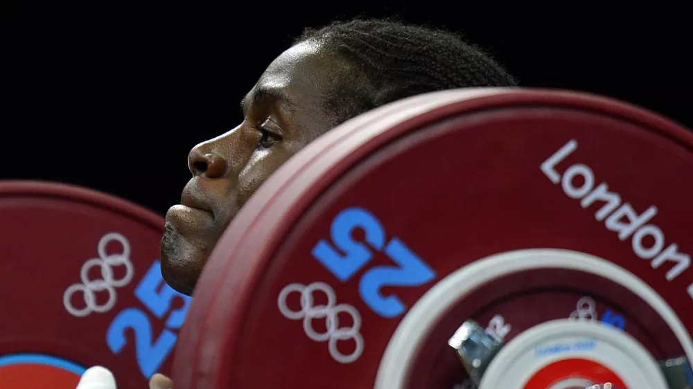 Cameroon's Madias Dodo Nzesso Ngake competes in the women's 75kg group B weightlifting event during the London 2012 Olympic Games at The Excel Centre in London on August 3, 2012.,Image: 139188005, License: Rights-managed, Restrictions:, Model Release: no 