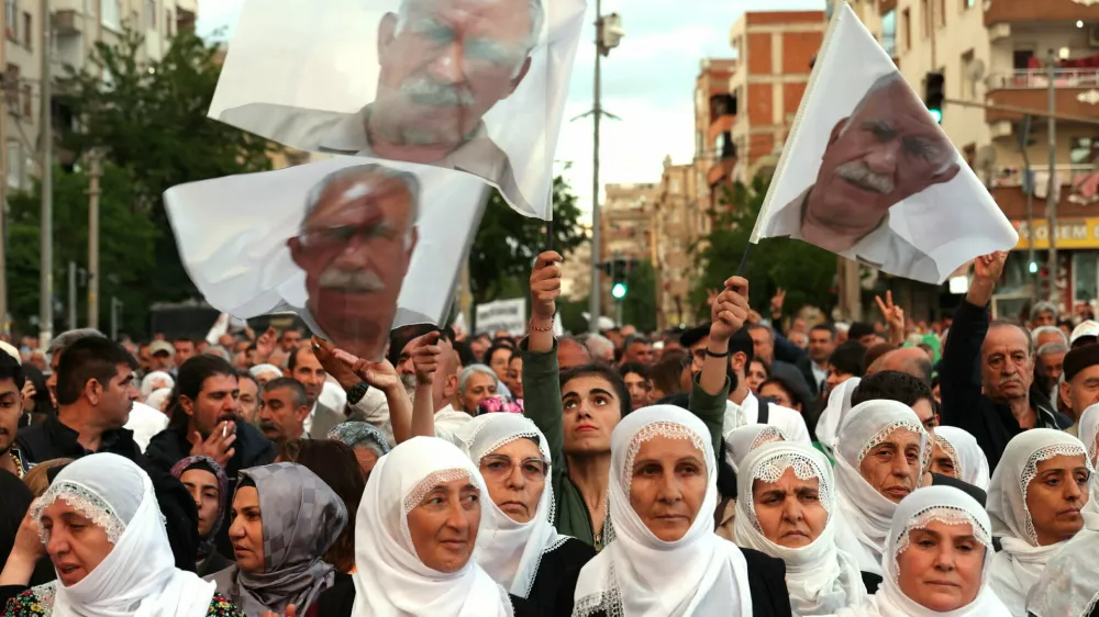 Supporters of the pro-Kurdish Peoples' Equality and Democracy Party (DEM Party) carry flags bearing an image of jailed Kurdish militant leader Abdullah Ocalan during a rally in Diyarbakir, Turkey, May 16, 2026. REUTERS/Sertac Kayar