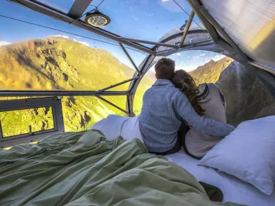 This is the worlds first hanging lodge suspended 1,200ft off the ground in Perus Sacred Valley of Cusco.Boasting stunning panoramic views, the Skylodge Adventure Suites capsules can fit up to eight people and each of the three luxurious cabins come complete with four beds, a dinning area and a private bathroom with an ecological toilet.Intrepid travelers have to climb the mountain to get to the capsule, via a secure climbing path which is fit for beginners, and are rewarded with 300 degree view of the majestic Sacred Valley once at the top.Measuring 24ft in length and 8ft in height and width, the pods are hand crafted out of aerospace aluminum and weather resistant polycarbonate.It costs around USD0 per person for a nights stay, and the price includes a sunrise breakfast enjoyed from the comfort of your personal capsule, as well as a gourmet dinner served up with wine.At the end of the stay, guests get back down the mountain via one of seven zip lines.Skylodge Adventure Suites became the worlds first hanging lodges after launching in June 2013. It was opened by a small company called Natura Vive, a group of young entrepreneurs whose philosophy was to create a mountain experience that people of all ages and abilities can enjoy.29 Jan 2018Pictured: Skylodge Adventure Suites are comprised of three luxurious cabins which hang 1,200ft in the air on a mountainside in Perus Sacred Valley of Cusco.,Image: 361729220, License: Rights-managed, Restrictions: World Rights, Model Release: no, Pictured: Skylodge Adventure Suites are comprised of three luxurious cabins which hang 1,200ft in the air on a mountainside in Perus Sacred Valley of Cusco 