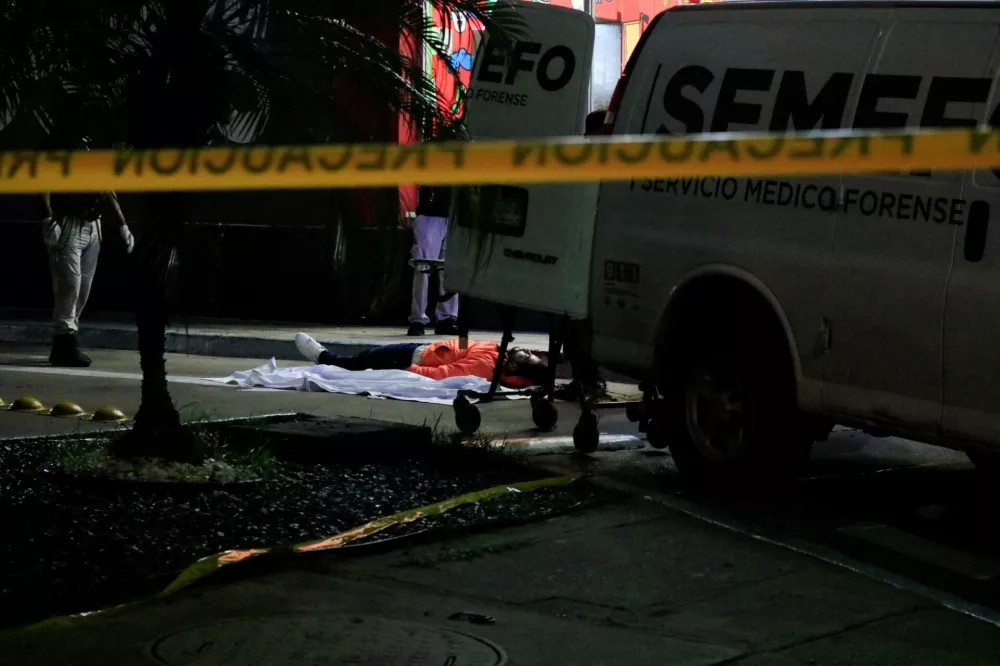 SENSITIVE MATERIAL. THIS IMAGE MAY OFFEND OR DISTURB  Forensic technicians and police officers work at the crime scene where Mexican social media influencer Cesar Gastelum, known for his comedy videos and followed by nearly 600,000 people on TikTok, was shot and killed while livestreaming with friends outside a fast-food restaurant in Culiacan, Sinaloa state, Mexico, August 4, 2026. REUTERS/Jesus Bustamante