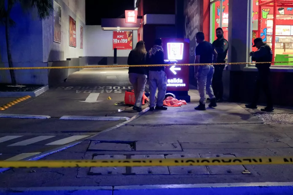 Forensic technicians and police officers work at the crime scene where Mexican social media influencer Cesar Gastelum, known for his comedy videos and followed by nearly 600,000 people on TikTok, was shot and killed while livestreaming with friends outside a fast-food restaurant in Culiacan, Sinaloa state, Mexico, August 4, 2026. REUTERS/Jesus Bustamante