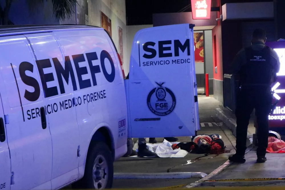 SENSITIVE MATERIAL. THIS IMAGE MAY OFFEND OR DISTURB  Forensic technicians and police officers work at the crime scene where Mexican social media influencer Cesar Gastelum, known for his comedy videos and followed by nearly 600,000 people on TikTok, was shot and killed while livestreaming with friends outside a fast-food restaurant in Culiacan, Sinaloa state, Mexico, August 4, 2026. REUTERS/Jesus Bustamante