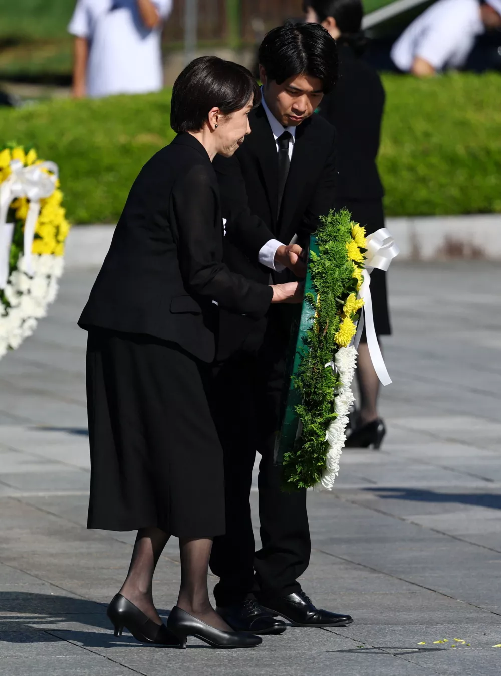 Japanese Prime Minister Sanae Takaichi receives a wreath before laying it during a memorial ceremony marking the 81st anniversary of the atomic bombing, at Hiroshima Peace Memorial Park in Hiroshima, western Japan, August 6, 2026. REUTERS/Issei Kato