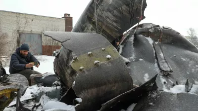 FILE PHOTO: A man photographs parts of an unidentified missile, which Ukrainian authorities believe to be made in North Korea and was used in a strike in Kharkiv earlier this week, amid Russia's attack on Ukraine, in Kharkiv, Ukraine January 6, 2024. REUTERS/Vyacheslav Madiyevskyy/File Photo