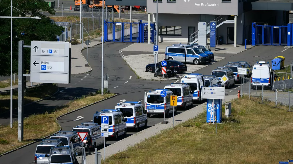 Police vehicles are parked at Leipzig/Halle Airport, where investigations are underway following the drone incident that occurred early Wednesday morning, in Schkeuditz, Germany, Thursday Aug. 6, 2026. (Hendrik Schmidt/dpa via AP)