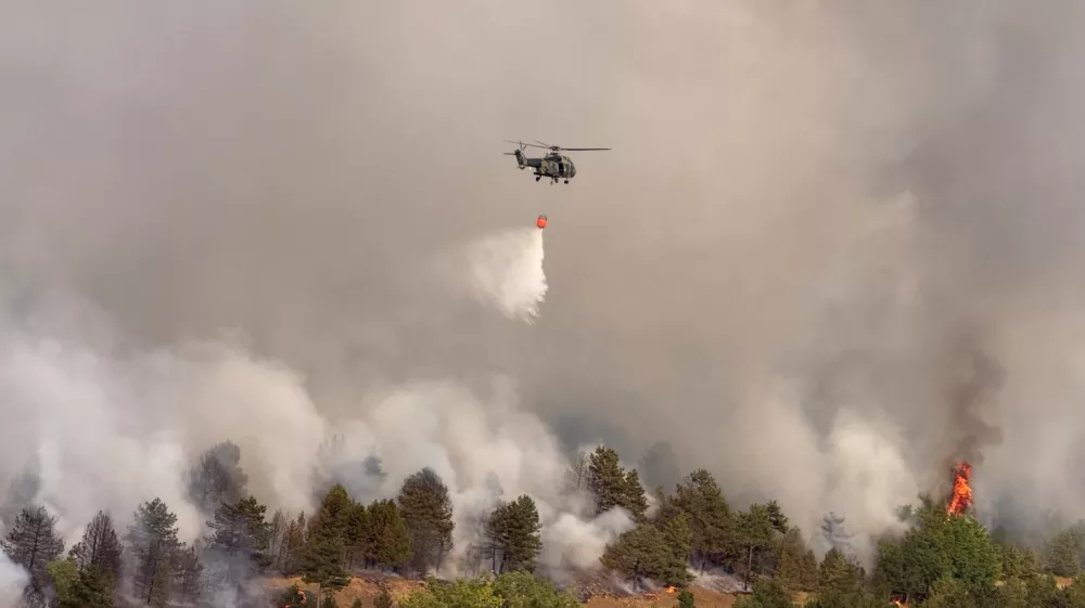In this photograph made available by the Serbian Ministry of Interior, a Serbian Police helicopter battles a fire in Deliblatska Pescara (Deliblato Sands), 70 kilometers north-west of Belgrade, Serbia, on Wednesday, Aug. 5, 2026. (Serbian Ministry of Interior via AP)