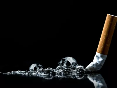 Cigarette ashes with skull.Tobacco cigarette butt on black background.World No Tobacco Day Concept Stop Smoking.