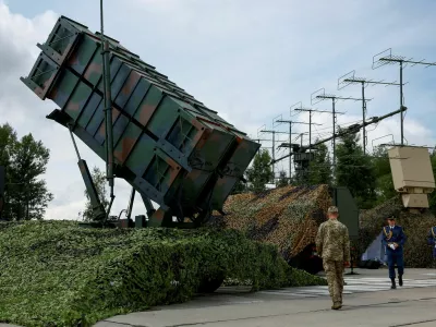 FILE PHOTO: Ukrainian service members walk next to a launcher of a Patriot air defence system, amid Russia's attack on Ukraine, in an undisclosed location, Ukraine August 4, 2024. REUTERS/Valentyn Ogirenko/File Photo/File Photo